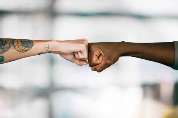 Colleagues fist bumping