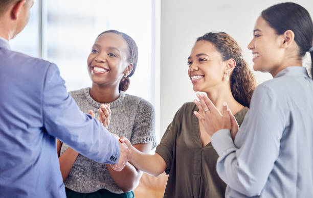 istock Shot of a group of colleagues clapping hands at work 1335045598