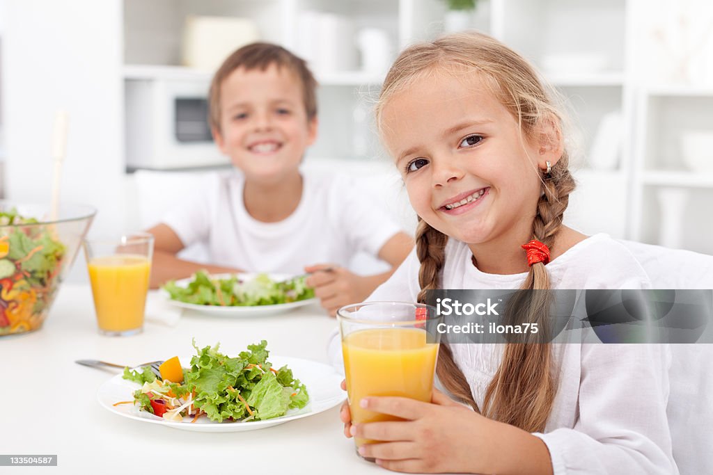 Kids eating a healthy meal Kids eating a healthy meal in the kitchen Beautiful People Stock Photo