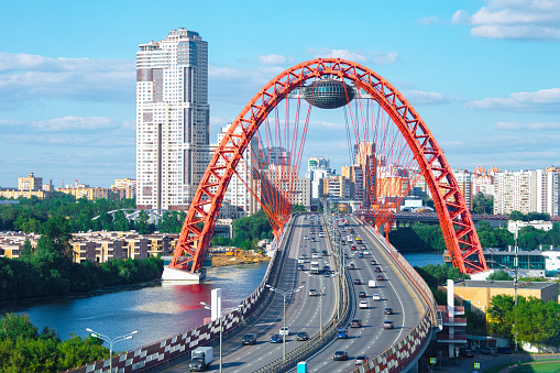 The picturesque bridge over the Moscow River (Zhivopisny Bridge) and a car traffic over it. High quality aerial photo