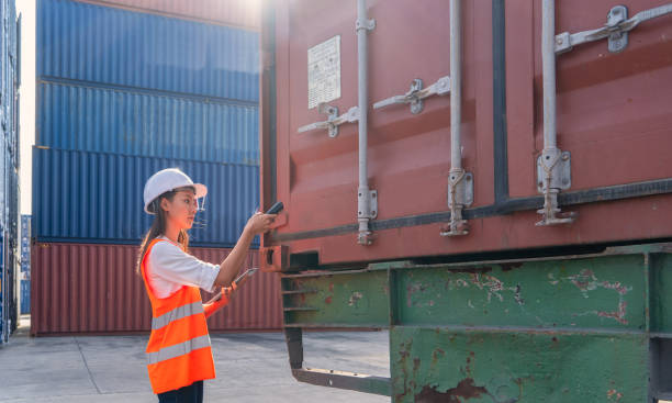 istock Engineers are overseeing the transportation of cargo with containers inside the warehouse. Container in export and import business and logistics. 1335051781