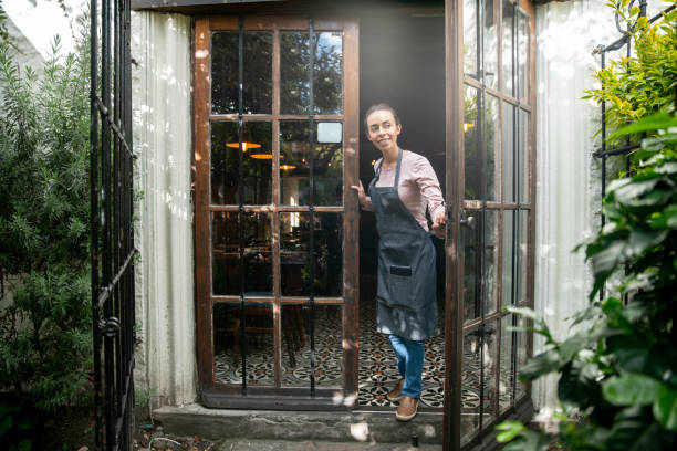 istock Waitress reopening the doors of a restaurant 1335052505