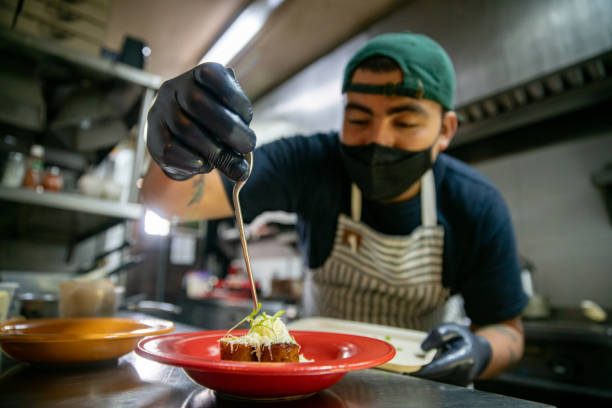 istock Cook preparing food at a restaurant wearing a face mask 1335052526