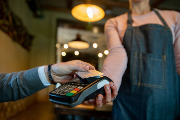 istock Close-up on a man making a contactless payment at a restaurant 1335052532