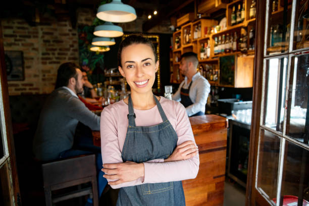 istock Happy waitress working at a bar 1335052576