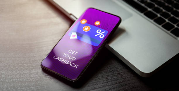 istock Cashback customer loyalty program concept. Smartphone with discount card with rewarding marketing points on the screen and text - get your cashback. Rewards and money refund service 1335052592