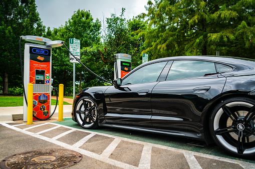 All Electric Porsche Taycan charging at a DC Fast Chargepoint charging station in Austin Texas on Electric Avenue. Powered by Texas wind energy
