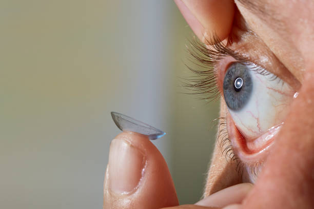 istock Man putting in contact lens in his eye 1335058155