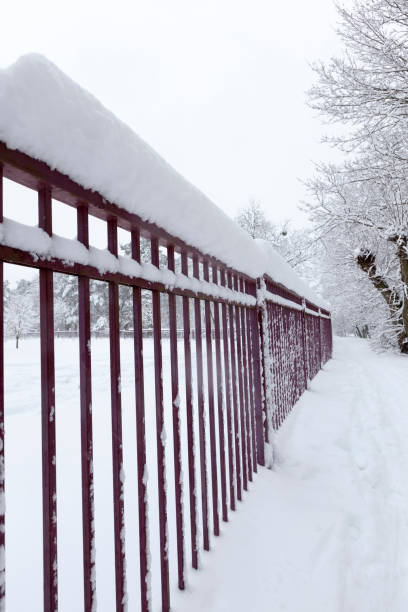 istock simple metal fence in winter 1335058213