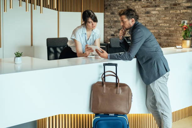 istock Businessman Using Digital Tablet for Checking In at Hotel 1335061118