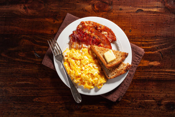 istock traditional scrambled egg breakfast with bacon and toast 1335061914