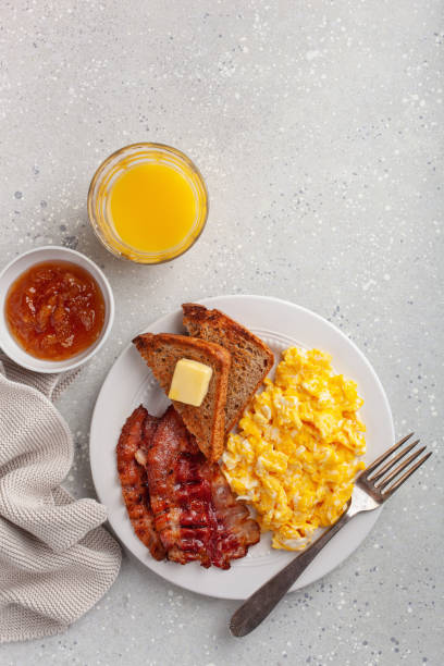 istock traditional scrambled egg breakfast with bacon and toast 1335062096