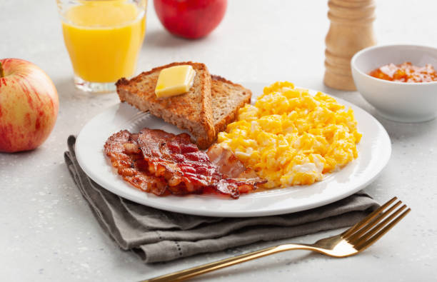 istock traditional scrambled egg breakfast with bacon and toast 1335062121