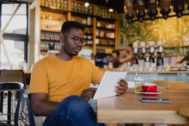 istock One African American man using a digital tablet computer in a coffee shop 1335062138