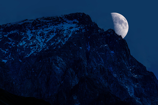 Mountain peak is covered with snow at night time