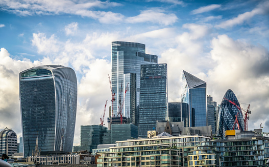 A daytime view of the towers of London's financial district, as seen from across the Thames.