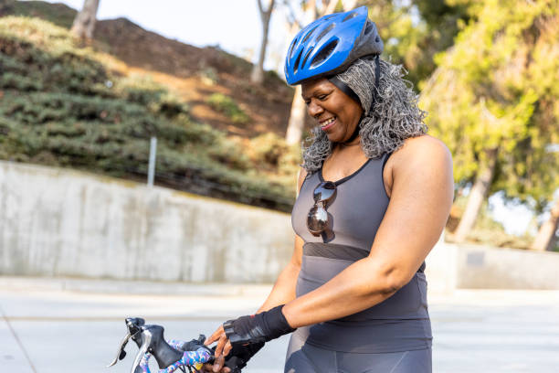 istock Senior Black Woman Riding Bicycle Portrait 1335068596