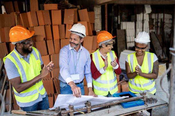 istock Construction workers applauding during informal meeting at a construction site 1335069249
