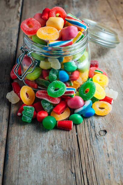istock Colorful candy gum on old wooden table 1335070062