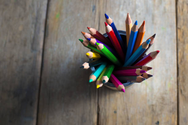 istock Colored pencils on wooden table 1335070242