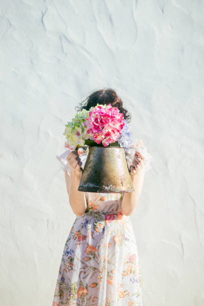 istock Woman holding flowers 1335070471