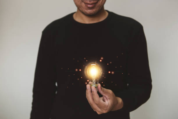 istock Hand holding light bulb. idea with innovation and inspiration.  innovative technology and solution creative business design concept. 1335070509