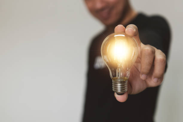 istock Hand holding light bulb. idea with innovation and inspiration.  innovative technology and solution creative business design concept. 1335070525