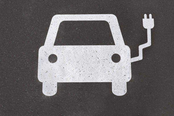 istock electric car charging station symbol painted on asphalt - e-mobility concept 1335074028