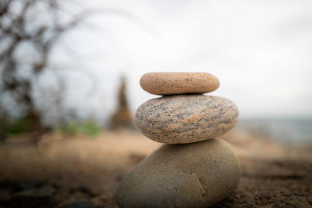 Stones stacked on the beach on Cape Cod. Image for mindfulness, inner strength, stability, and balance with space for text and design.