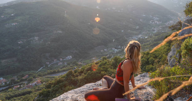 istock Female rock climber relaxes on mountain ridge 1335074833