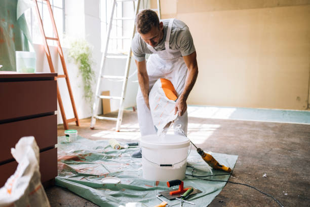 istock Man Pouring Plaster in a Bucket 1335074966