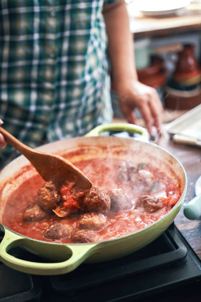 istock Preparing Meatballs with Tomato Sauce in a Pan 1335075771
