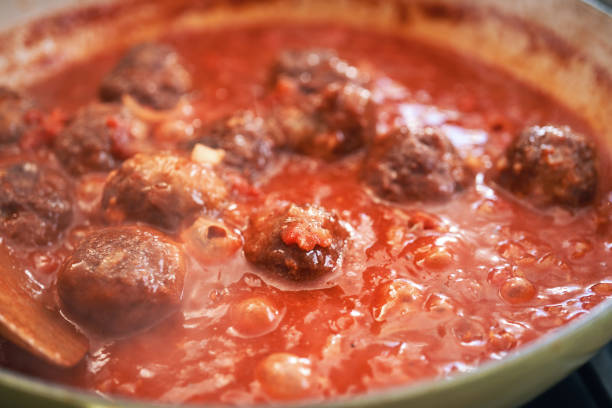 istock Preparing Meatballs with Tomato Sauce in a Pan 1335075796