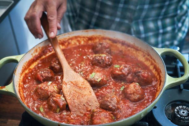 istock Preparing Meatballs with Tomato Sauce in a Pan 1335075814
