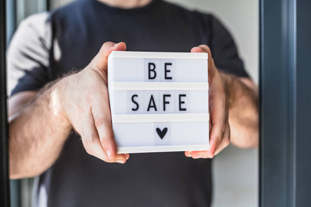 istock Man holding lightbox with text Be safe in his hand 1335078133