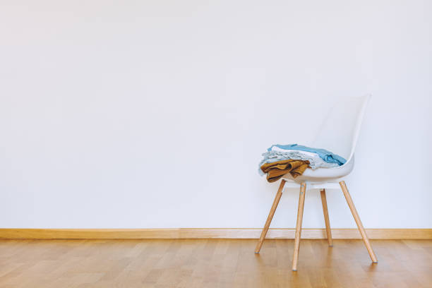 istock Indoors flat wall mockup with Clothes on Chair 1335078192