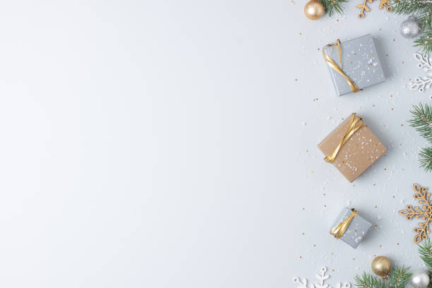 istock Christmas decorations with packaging gifts and Christmas tree on grey background. Flat lay, copy space 1335079907