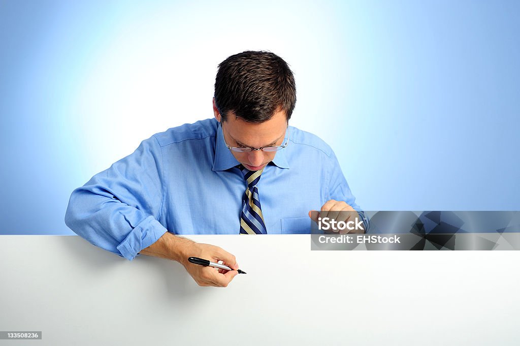 Businesman leaning on white card holding pen with blue background Businesman white card with blue background, holding pen  Adult Stock Photo