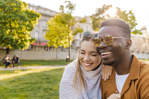 istock Interracial couple embracing outdoors and laughing 1335083195