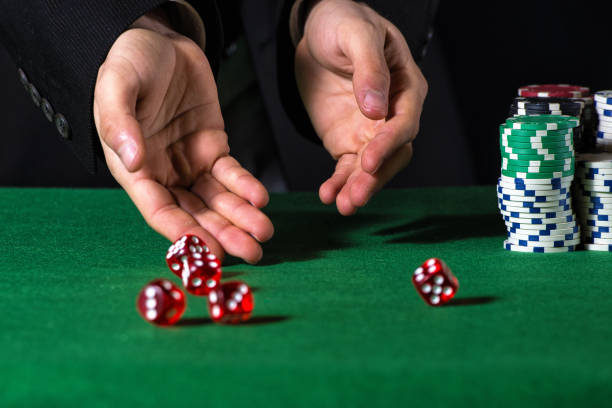 istock Close-up of hands throwing dice in casino 1335083549