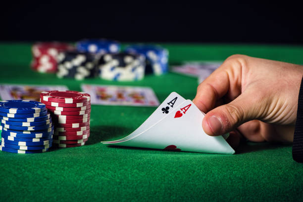istock Closeup of poker player with two aces 1335083595