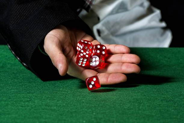 istock Close-up of hands throwing dice in casino 1335083603