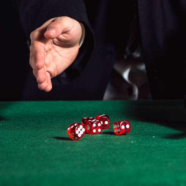 Close-up of hands throwing dice in casino stock photo
