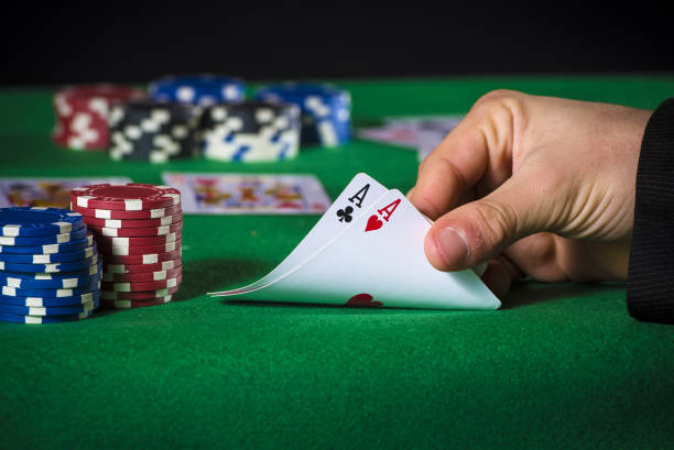 istock Close-up of poker player with two aces 1335083661