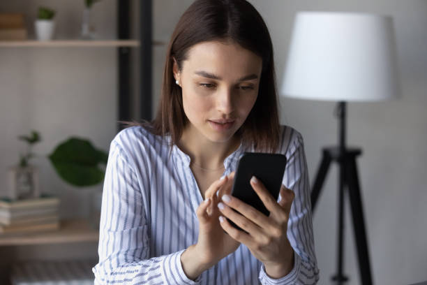 istock Young Caucasian woman use cellphone browsing internet 1335085223