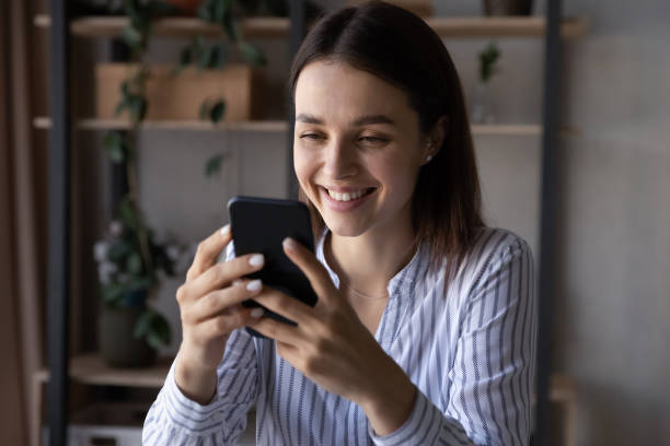 istock Smiling woman use cellphone speak on webcam call 1335085225