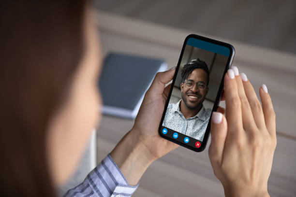 istock Close up of multiracial people talk on webcam on cell 1335085229