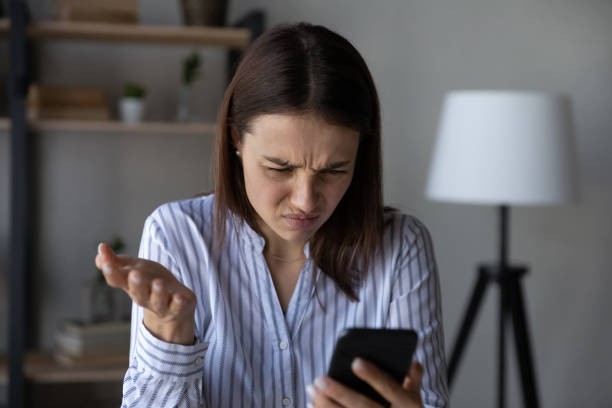 istock Unhappy woman distressed having problems with cellphone 1335085244