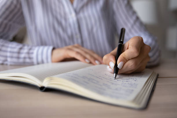 istock Close up of woman write make notes in notebook 1335085257