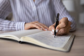 Close up of woman write make notes in notebook